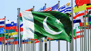 A handshake between diplomats with national flags in the background.