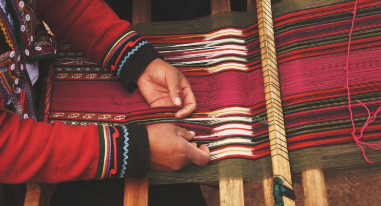 Artisan weaving traditional handloom fabric in pakistan