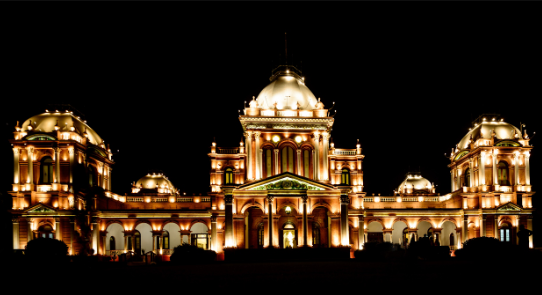 Noor Mahal lit up at night, reflecting architectural elegance.