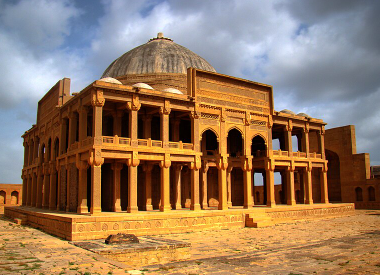 Ancient tomb structures at Makli Necropolis under the open sky.
