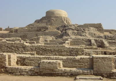 Ruins of Mohenjo-Daro, an ancient Indus Valley civilization site with brick structures and historical artifacts.