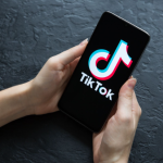 TikTok logo glowing beside a Pakistani Rupee sign on a digital backdrop