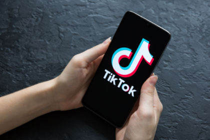 TikTok logo glowing beside a Pakistani Rupee sign on a digital backdrop