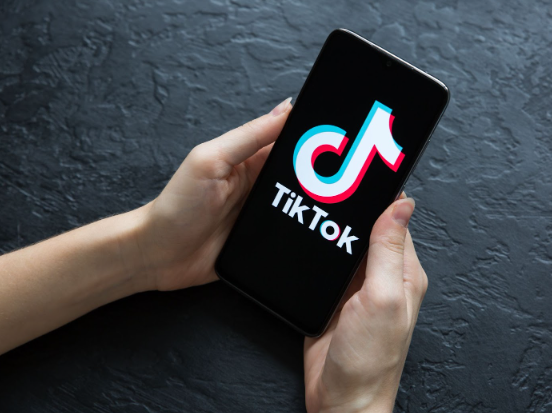TikTok logo glowing beside a Pakistani Rupee sign on a digital backdrop