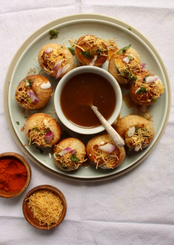 Close-up of crispy gol gappay filled with potatoes and spicy water