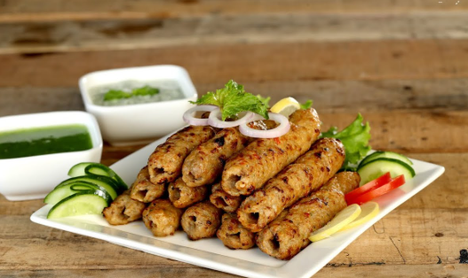 Juicy seekh kebabs cooking on a traditional charcoal grill